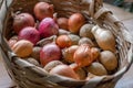 Onion and potatoes in wicker basket Royalty Free Stock Photo