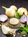 Onion powder in bowl on burlap Royalty Free Stock Photo