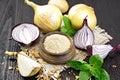 Onion powder in bowl on wooden board Royalty Free Stock Photo