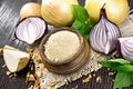 Onion powder in bowl on wooden table Royalty Free Stock Photo