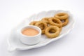 Fried onion rings in white plate on white background Royalty Free Stock Photo