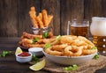 Onion rings in batter with sauce and cheese sticks. Beer snacks. Royalty Free Stock Photo