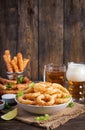 Onion rings in batter with sauce and cheese sticks. Beer snacks. Royalty Free Stock Photo