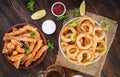 Onion rings in batter with sauce and cheese sticks. Beer snacks. Royalty Free Stock Photo