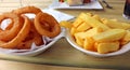 Onion rings and chunky chips Royalty Free Stock Photo