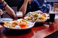 Onion rings, Nach Salad and pint of Stout Black Beer on wooden table at the bar Royalty Free Stock Photo