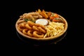 onion rings nuggets french fries ribs potato wedges white sauce on a wooden plate1