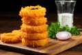 onion rings stacked like a pyramid on a chopping board