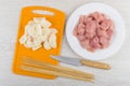 Onion and skewers on cutting board, raw chicken meat, knife Royalty Free Stock Photo