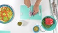 Onion slices on a cutting board, woman hands, top view on white background Royalty Free Stock Photo