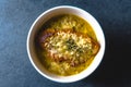 Onion soup with cheese, croutons and thyme in a ceramic bowl on a blue stone Royalty Free Stock Photo