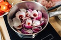 Onions borettane pickles in a saucepan filled with red wine. Delicacy, a dish from the chef.