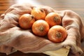 Onions. Box with onions under sun light on the rustic table Royalty Free Stock Photo