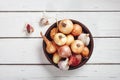 Onions and garlic in a bowl on a white wooden background. Royalty Free Stock Photo