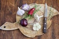Onions, garlic, thyme and hot pepper on old cutting board. Royalty Free Stock Photo