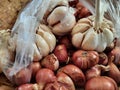 Onions and garlics in a plastic bag on traditional market