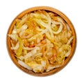 Onions, golden brown roasted, in a wooden bowl Royalty Free Stock Photo