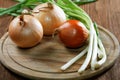 Onions napiform and green on an rural table Royalty Free Stock Photo