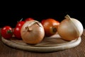 Onions napiform tomatoes on an old table Royalty Free Stock Photo