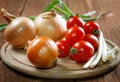 Onions napiform tomatoes on an old table Royalty Free Stock Photo