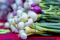 Onions stacked on a table for sale at a local farmers market Royalty Free Stock Photo