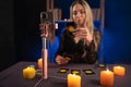 Online astrology. The fortune teller is use a smartphone, reads tarot cards for predictions, telling customers by