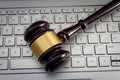 Online auction or cyberspace laws and regulations concept with wooden judge gavel on laptop computer keyboard