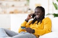 Online Banking. African American Guy Talking On Cellphone And Holding Credit Card Royalty Free Stock Photo