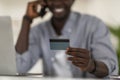 Online Banking. Unrecognizable Black Male Holding Credit Card And Talking On Cellphone Royalty Free Stock Photo