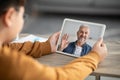 Online Call. Little Biy Using Digital Tablet For Video Chat With Grandfather