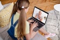Online Call. Little Girl Using Laptop For Video Chat With Grandmother