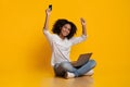 Happy Black Woman Celebrating Success With Laptop And Credit Card