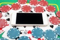 online casino concept, chips, cards and dice lie next to a smartphone on the table. Royalty Free Stock Photo