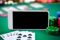 Online casino concept, playing cards, dice chips and smartphone Royalty Free Stock Photo