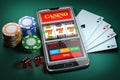 Online casino and gambling concept. Slot machine on smartphone screen, cards, dice and poker chips Royalty Free Stock Photo