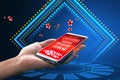 Online casino and gaming, gambling on device concept. Close up of female hand holding smartphone with creative slot machine and Royalty Free Stock Photo