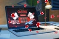 Online casino and gaming, gambling on device concept. Close up of laptop at workplace with creative slot machine and other games. Royalty Free Stock Photo