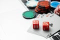 Online casino laptop. Laptop keyboard and chips with dice and playing cards on a green gaming table. Game addiction gambling Royalty Free Stock Photo