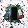 Online casino, mobile casino, mobile phone, chips cards on a green background. Gambling games. View from above Royalty Free Stock Photo