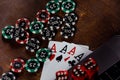 Online casino theme. Playing chips, red dices, cards with aces and laptop on a wooden background Royalty Free Stock Photo