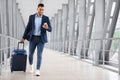 Online Check In. Handsome Arab Man Walking In Airport And Using Smartphone Royalty Free Stock Photo