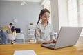 Online child education at home. Girl teaches lesson video chat call conference with teacher using laptop at home. Royalty Free Stock Photo