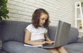 Online child education. Little girl makes video chat lesson laptop at home. Royalty Free Stock Photo