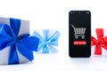 Online Christmas. Internet shop application on digital smartphone screen with gift box red ribbon in online shopping Royalty Free Stock Photo