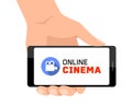 Online cinema concept with movie camera icon. Hand holding smartphone Royalty Free Stock Photo