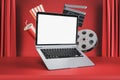 Online cinema movie watching concept with blank white modern laptop screen with space for your logo or text on red cinema