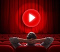 Online cinema screen with red curtain and play media button in center