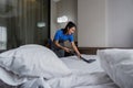 online cleaning service, hotel cleaning service clean up bedroom after guests arrive . housekeeper cleaning dust and Royalty Free Stock Photo