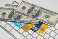 Online Commerce, Ecommerce, credit and debit cards with dollars and a keyboard. Royalty Free Stock Photo