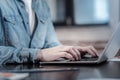 Young male hands typing on laptop